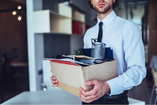 employee holding box of personal items